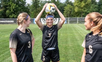 female soccer players with soccer ball